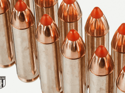 Multiple copper-plated bullets with red polymer tips arranged in close-up view